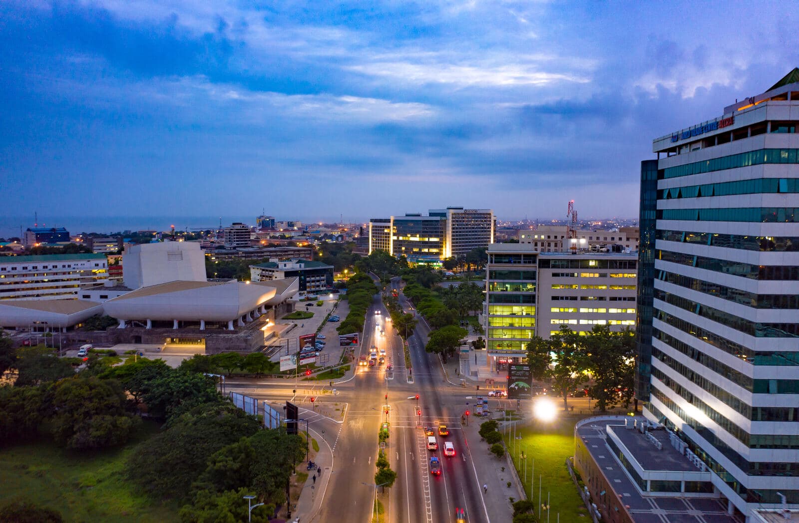 Accra from the air at dusk, its streets and towers lit up